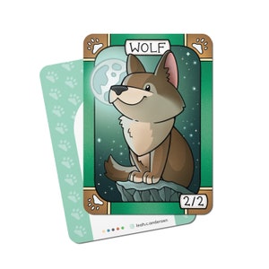May include: A green card with a cartoon wolf illustration. The card has a brown border and the text "WOLF" in a brown rectangle at the top. The wolf is sitting on a rock with a full moon in the background. The card has the text "2/2" in the bottom right corner.