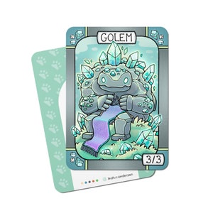 May include: A card game card with a blue and gray golem creature made of crystals, sitting on a bed of crystals and knitting a purple and blue scarf. The card has the text "GOLEM" and "3/3" on it.