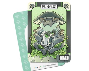 May include: A fantasy art card featuring a mushroom creature holding a skull. The card has the word "FUNGUS" at the top and "1/1" at the bottom. The card is primarily gray, green, and white, with a light green background.