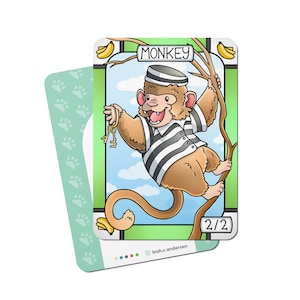 May include: A cartoon illustration of a monkey wearing a striped prison uniform and holding keys. The monkey is sitting on a branch with bananas hanging from it. The card has the word "MONKEY" and the number "2/2" printed on it.