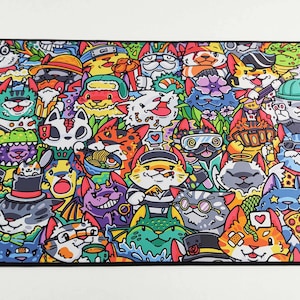 May include: A colorful mousepad featuring a repeating pattern of cartoon cats wearing various hats, sunglasses, and accessories. The cats are drawn in a whimsical style and are surrounded by a variety of other objects, including hearts, stars, and musical notes.