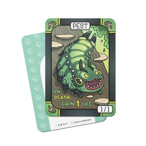 May include: A trading card featuring a green cartoon caterpillar labeled "PEST." The card has the text "ON DEATH, GAIN 1 LIFE" and a 1/1 indicator. A second card with paw prints is partially visible in the background.