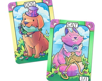May include: Two illustrated playing cards featuring a dog and a cat. The dog card is pink and blue with a light blue background and the text "DOG". The cat card is green and yellow with a light blue background and the text "CAT".