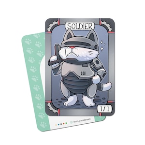 May include: A trading card featuring a cartoon cat wearing a futuristic soldier outfit, holding a gun and standing on a gray background. The card is titled "SOLDIER" and has a 1/1 designation.
