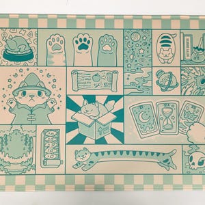 May include: A rectangular, mint green and white checkered mat featuring a whimsical cat-themed design. The artwork includes cat paws, a wizard cat, tarot cards, and other fantasy elements. The mat has a light green border.