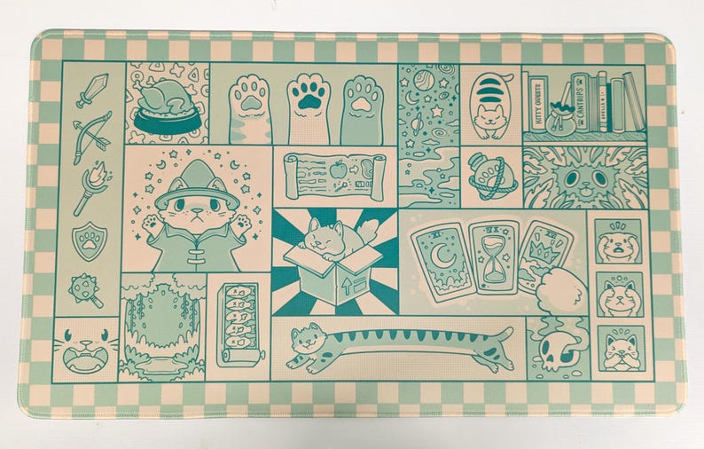 May include: A rectangular, mint green and white checkered mat featuring a whimsical cat-themed design. The artwork includes cat paws, a wizard cat, tarot cards, and other fantasy elements. The mat has a light green border.
