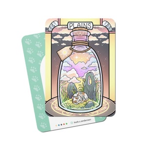 May include: A whimsical illustration of a glass bottle with a cork stopper, containing a miniature landscape with a cat sleeping in the grass. The bottle is labeled "PLAINS" and has a sun and clouds inside. The background is a yellow and orange gradient with a decorative border.