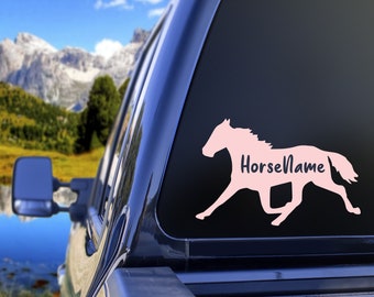 May include: Pink horse silhouette decal with the text "HorseName" on a black truck window.