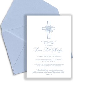 May include: A light blue invitation and envelope set. The invitation features a cross design with floral accents and text that reads "Please join us for the baptism of our son, Vince Neil Hodges". The envelope is open, revealing the invitation.