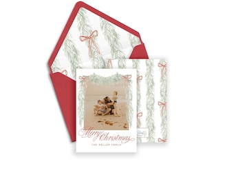 May include: A Christmas card featuring a photograph of a family and their dog on a beach. The card has a green garland with red bows and the text "Merry Christmas" and "The Keller Family".