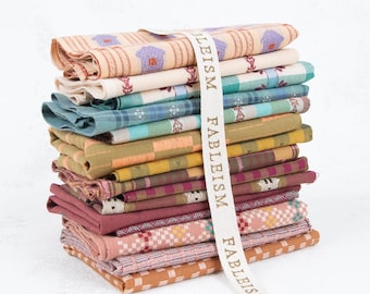 May include: A stack of folded fabric pieces in various colors including cream, teal, mustard yellow, maroon, and pink. The fabrics feature woven patterns like stripes, plaids, and small geometric shapes. A white ribbon labeled FABLEISM wraps the stack.