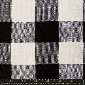 May include: Close-up of a black and white checkered fabric. The pattern features large, evenly sized squares in alternating black and white. The fabric has a textured appearance. The text "RUBY STAR SOCIETY" is visible at the bottom.