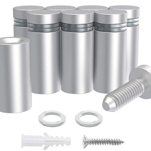 May include: A collection of silver-colored standoffs, designed for mounting. The set includes cylindrical standoffs, screws, washers, and wall anchors. The standoffs have a brushed metal finish and are designed to hold panels or signs.