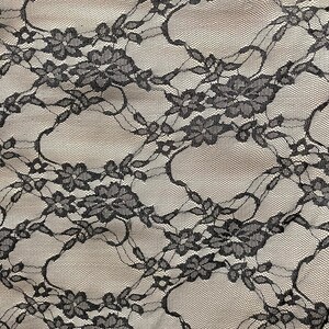 May include: Black lace fabric with a delicate floral pattern. The fabric is sheer and has a soft, flowing texture.