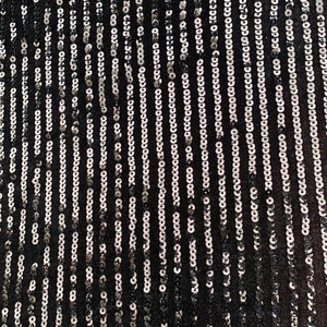 May include: Black fabric with silver sequins arranged in vertical lines.