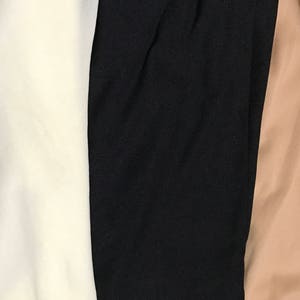 May include: Three fabric swatches, one white, one black, and one beige.