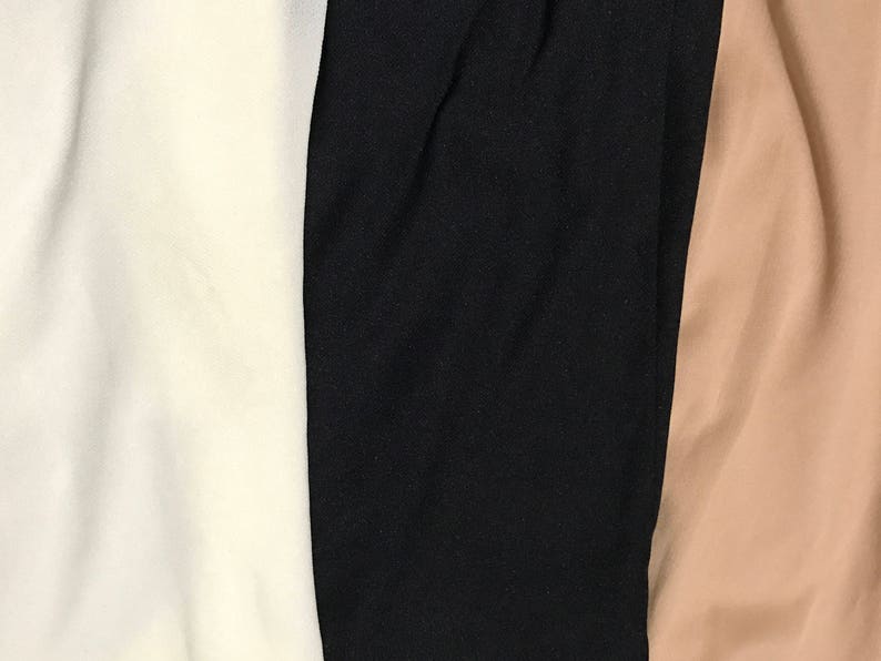 May include: Three fabric swatches, one white, one black, and one beige.