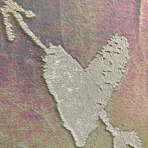 May include: A white heart with an arrow through it, made of iridescent sequins on a pink and blue background.