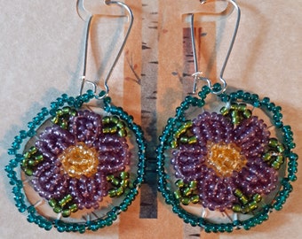 Beaded Birch Bark Earrings - A floral design with sparkly light purple glass beads with teal edge beading and green leaves, yellow center.