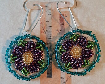 Beaded Birch Bark Earrings - A floral design with sparkly deep amethyst glass beads with teal edge beading and green leaves, yellow center.