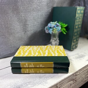 May include: Two small, hardback books with green covers and yellow patterned spines. The spines have the text "Jest Est Eller Ellers" and "Bader's Readers Gest Doks".