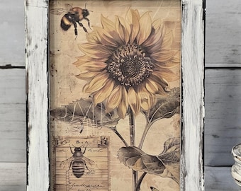 May include: A framed print featuring a sunflower and bee illustration. The artwork has a vintage aesthetic with a distressed white frame. The image includes a large sunflower, a bee, and a butterfly, with text elements in the background.