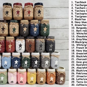 May include: Thirty mason jars painted in various two-tone color combinations. Each jar has a distressed finish and a star design. The jars are numbered 1 through 30 and the color combinations are listed next to the numbers.