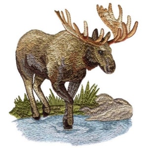 May include: Embroidered image of a brown moose with large antlers standing in a stream of water. The moose is facing right and has a brown body with a light brown head. The antlers are a light brown color and are spread wide. The stream of water is a light blue color and there is green grass on either side of the stream.