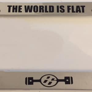 May include: A silver license plate frame with the text "THE WORLD IS FLAT" in black lettering. The frame also features a black and white stylized logo of a car engine with the number "15" in the center.