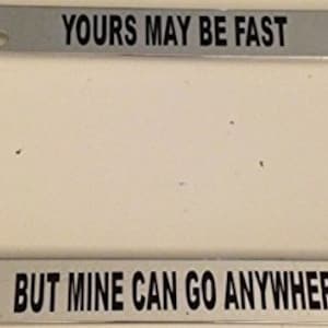 May include: Chrome license plate frame with the text "Yours may be fast, but mine can go anywhere".
