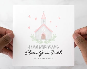 Può includere: Un biglietto bianco con un'illustrazione ad acquerello di una chiesa con un tetto rosa e un campanile. Il biglietto ha il testo "ON YOUR CHRISTENING DAY TO A VERY SPECIAL DAUGHTER Olivia Grace Smith 24TH MARCH 2024" stampato su di esso.