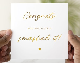 May include: A white card with gold foil lettering that reads "Congrats you absolutely smashed it!" with a gold star below the text.