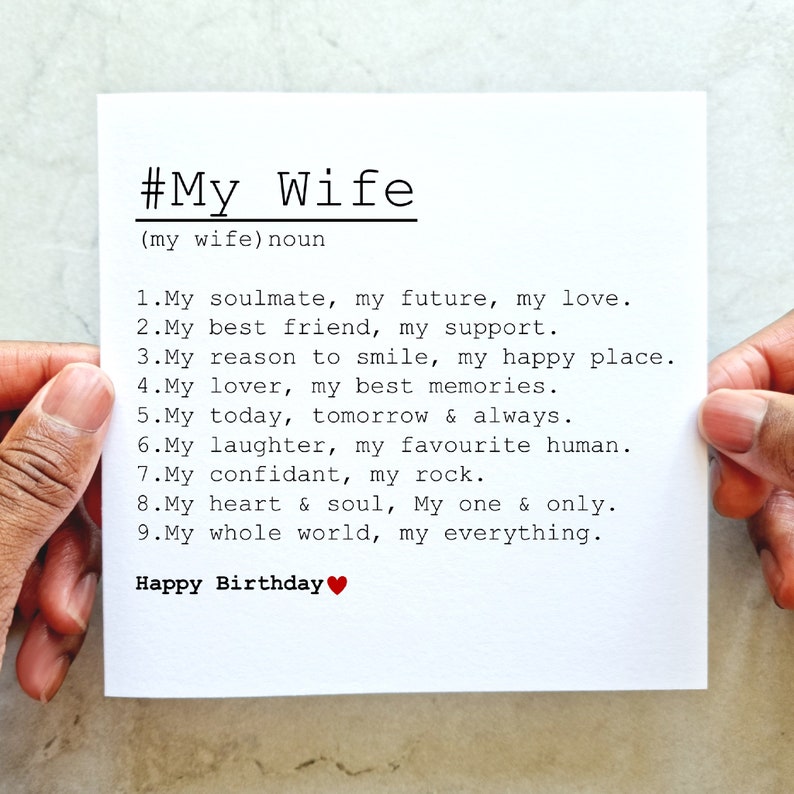 May include: A white card with black text that reads "#My Wife (my wife) noun 1. My soulmate, my future, my love. 2. My best friend, my support. 3. My reason to smile, my happy place. 4. My lover, my best memories. 5. My today, tomorrow & always. 6. My laughter, my favourite human. 7. My confidant, my rock. 8. My heart & soul, My one & only. 9. My whole world, my everything. Happy Birthday" with a red heart symbol.