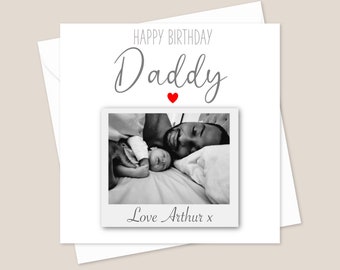 May include: A black and white photo of a father and his baby son sleeping in bed. The card reads "Happy Birthday Daddy" with a red heart and "Love Arthur x".