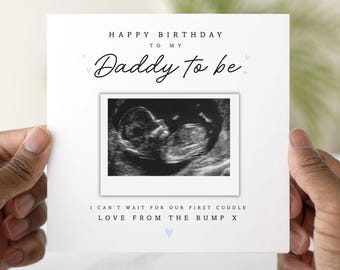 May include: A white greeting card with the text "HAPPY BIRTHDAY TO MY Daddy to be" in black script. The card includes a sonogram image and the message "I CAN'T WAIT FOR OUR FIRST CUDDLE LOVE FROM THE BUMP X".