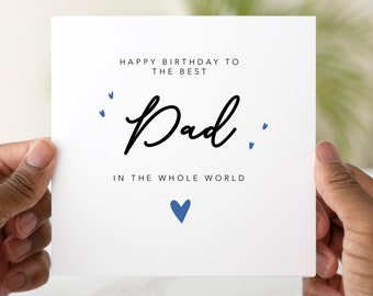 May include: White card with blue hearts and the text "Happy Birthday to the best Dad in the whole world".
