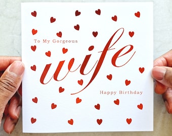 May include: A white card with red foil hearts and the text "To My Gorgeous Wife Happy Birthday".
