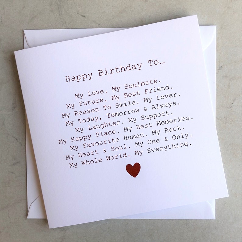 May include: A white card with a red heart at the bottom. The card has a message that reads "Happy Birthday To... My Love. My Soulmate. My Future. My Best Friend. My Reason To Smile. My Lover. My Today, Tomorrow & Always. My Laughter. My Support. My Happy Place. My Best Memories. My Favourite Human. My Rock. My Heart & Soul. My One & Only. My Whole World. My Everything."