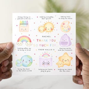 May include: A square greeting card with a watercolour design. The card features illustrations of a rainbow, suns, a backpack, and stars. Text includes "Thank You So Much For..." and other phrases. The card is held by a person.