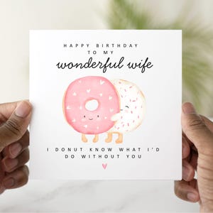 May include: A white card with a pink and white donut illustration. The card reads "Happy Birthday to my wonderful wife. I donut know what I'd do without you."