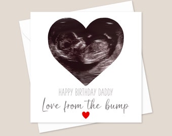 May include: A white card with a black and white ultrasound image in the shape of a heart. The text "Happy Birthday Daddy Love from the bump" is written in gray with a small red heart below the text.