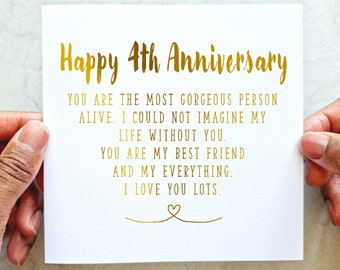 May include: A white card with gold lettering that reads "Happy 4th Anniversary". The card has a message that reads "You are the most gorgeous person alive. I could not imagine my life without you. You are my best friend and my everything. I love you lots."