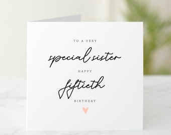 May include: A white card with black text that reads "To a very special sister Happy fiftieth Birthday" with a pink heart at the bottom.