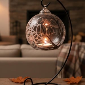 Spider web rounded with tree's branches, black and white, hanging glass, shadow candle holder.