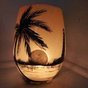 Sunset in the sea palm tree and lighthouse