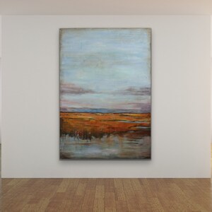 May include: Abstract landscape painting with a blue sky, orange and brown fields, and a reflection of the sky in the water.