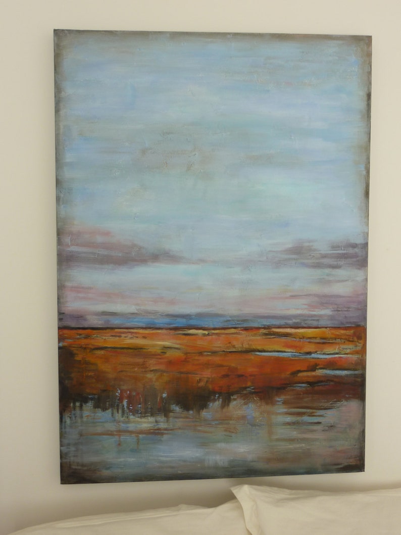 May include: Abstract landscape painting with a blue sky, brown and orange land, and a blue reflective water surface.