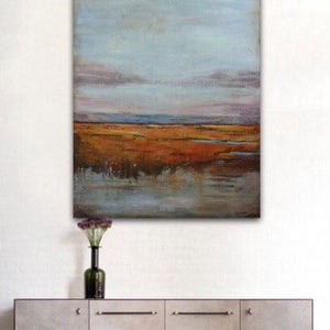 May include: Abstract landscape painting with a blue sky, orange and brown fields, and a reflection of the sky in the water.