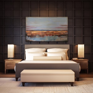 May include: A bedroom with a grey bed, white bedding, and a beige bench. Two wooden bedside tables with lamps flank the bed. Above the bed is a landscape painting in blue, orange, and brown. The dark brown wall behind the bed has a grid pattern.