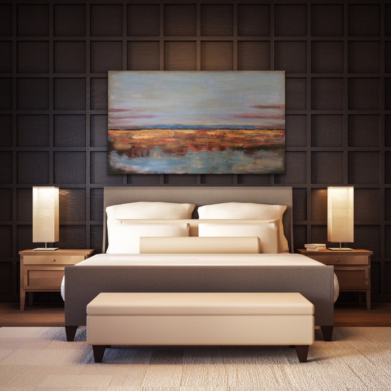 May include: A bedroom with a grey bed, white bedding, and a beige bench. Two wooden bedside tables with lamps flank the bed. Above the bed is a landscape painting in blue, orange, and brown. The dark brown wall behind the bed has a grid pattern.